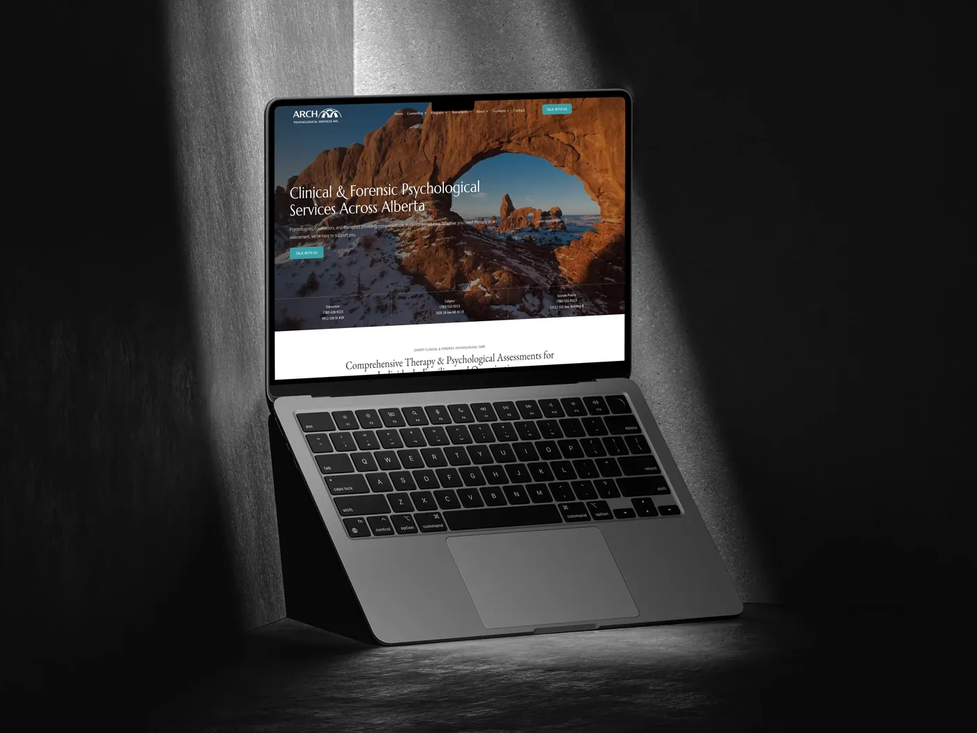 Arch Psychological website on a laptop