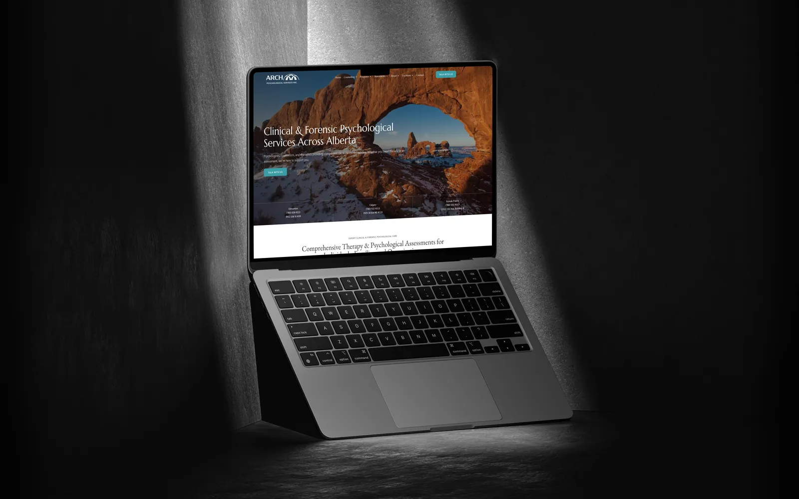 Arch Psychological website on a laptop